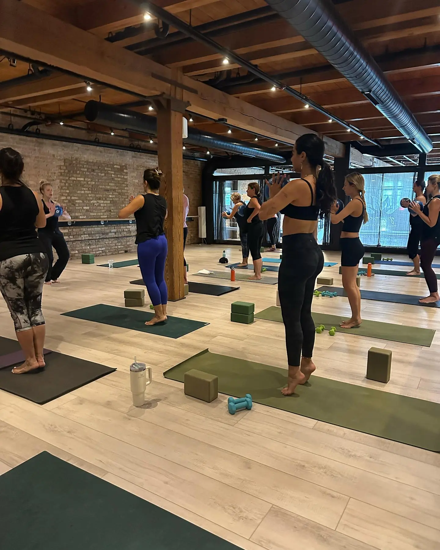Students practising together on mats in the GROW Wellness studio